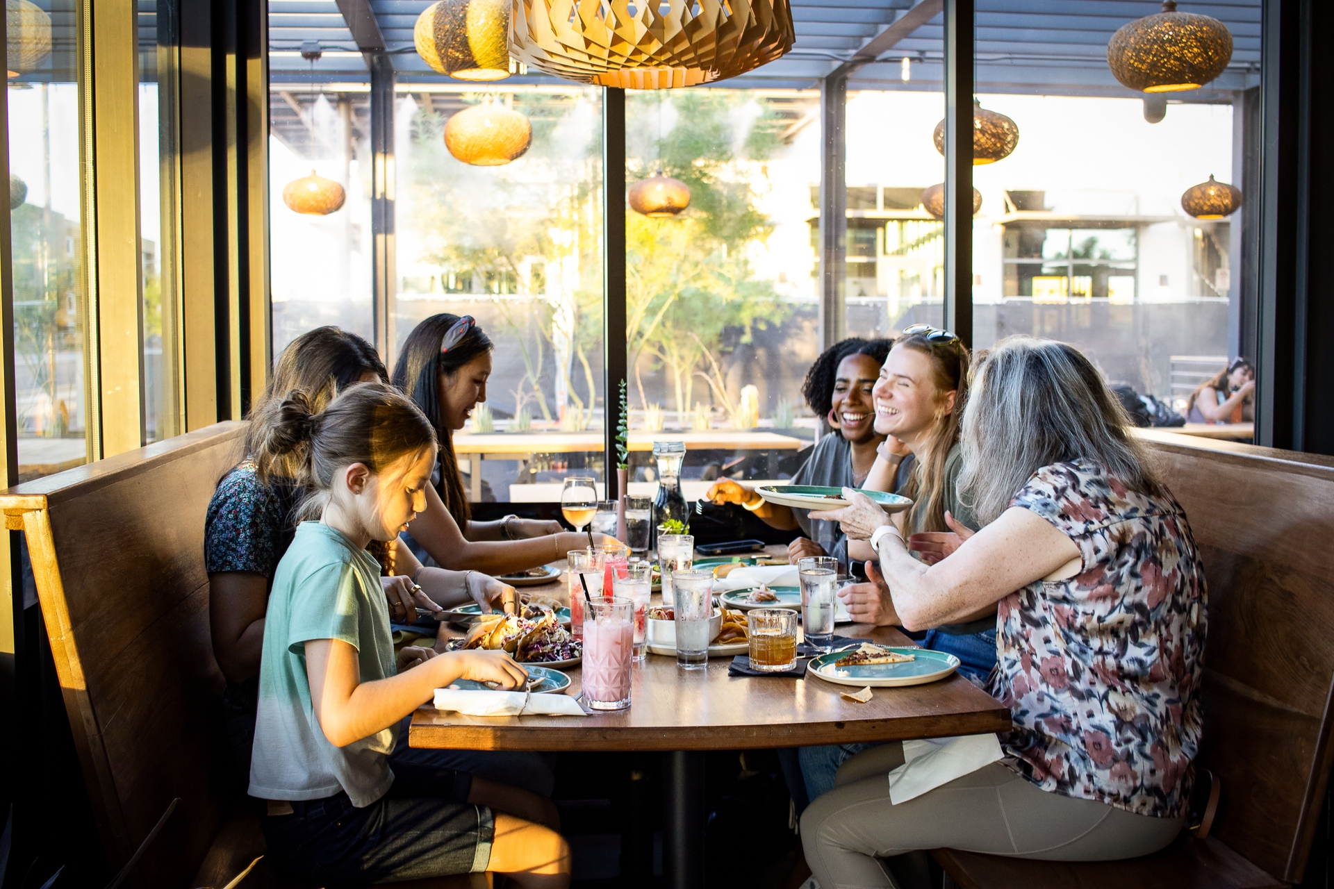 Group having dinner at a restaurant during golden hour